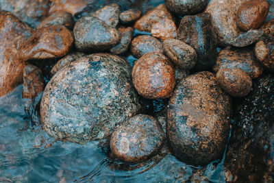 Close-up of pebbles by water