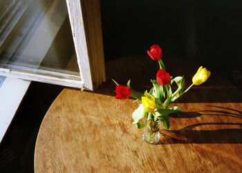 High angle view of roses in vase on table