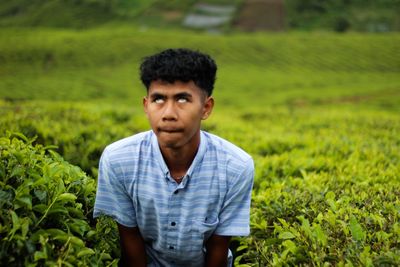 Portrait of young man on field