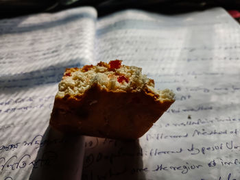 A half eaten fruit cake close-up shot when the morning sun shines on that cake.