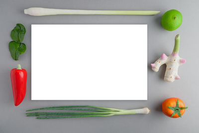 Directly above shot of fruits on table against white background