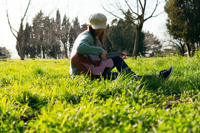 Full length of man sitting on field