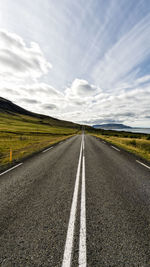 Road by landscape against sky