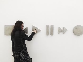 Woman standing against wall