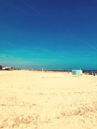 Scenic view of beach against blue sky