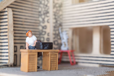 Man sitting on chair against building