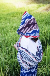 Rear view of woman standing on field