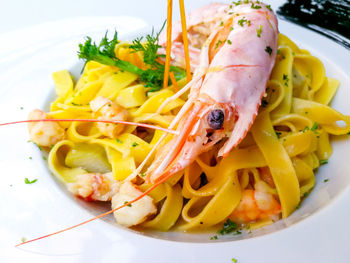 Close-up of seafood served with tagliatelle in bowl