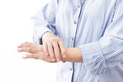 Close-up of hands against white background