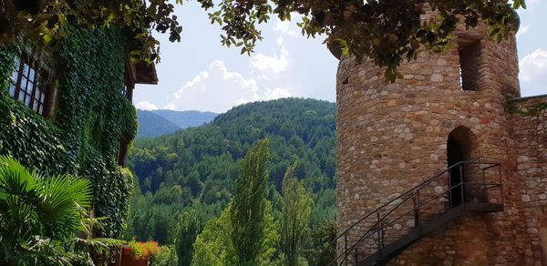 Panoramic view of trees and buildings against sky