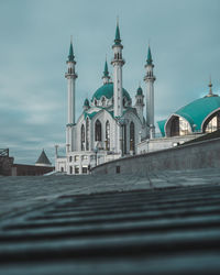 View of mosque against buildings in city