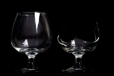 Close-up of wine glass against black background