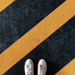 Low section of person standing on road