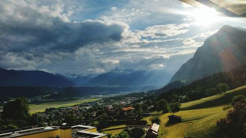 Aerial view of buildings and mountains against sky