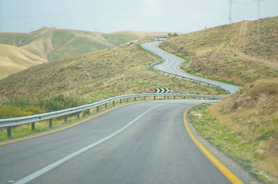 Empty road leading towards mountains