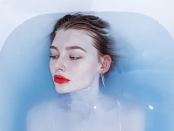 High angle view of thoughtful beautiful woman relaxing in bathtub