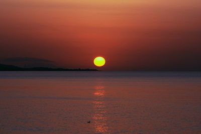 Scenic view of sea against romantic sky at sunset