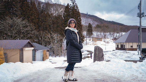 Portrait of woman standing on snow