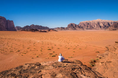 Person sitting in desert