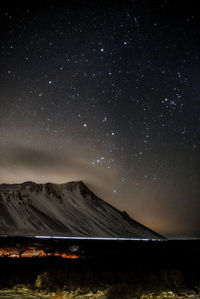 Scenic view of mountains against sky at night