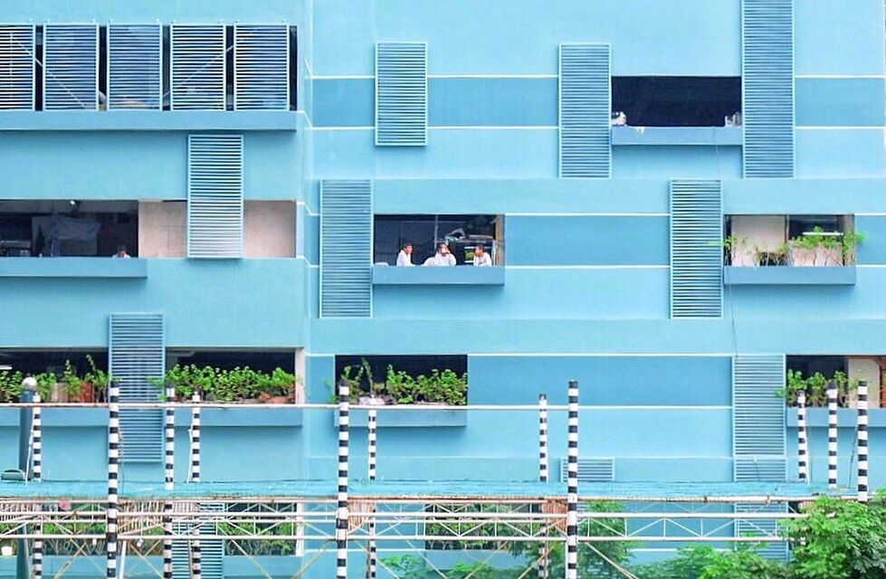 REFLECTION OF MAN ON SWIMMING POOL IN OFFICE