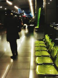 Woman standing on escalator