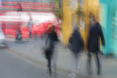 Blurred motion of people walking in city