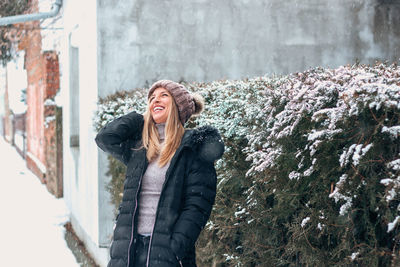 Young woman standing in snow