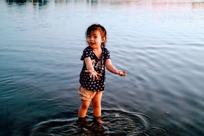 Full length of cute boy standing in water mekong river
