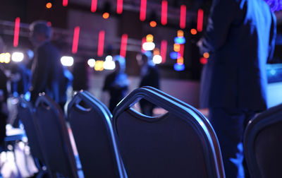 Empty chairs in the first row at conference before the event