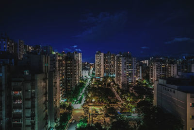 High angle view of illuminated buildings in city at night