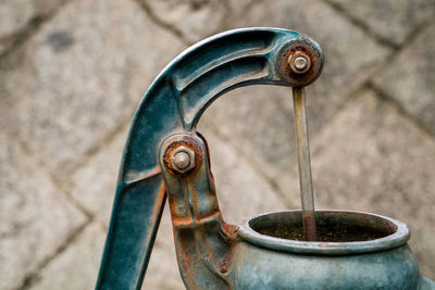 Close-up of old faucet against wall