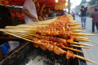 Close-up of woman preparing food at market