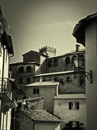 Low angle view of buildings in town against sky