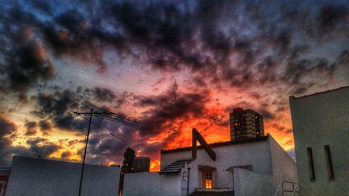 Buildings against cloudy sky