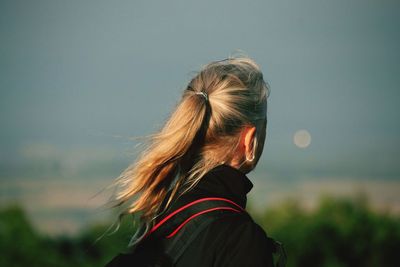 Rear view of woman against sky