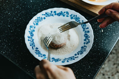 Midsection of woman holding ice cream in plate