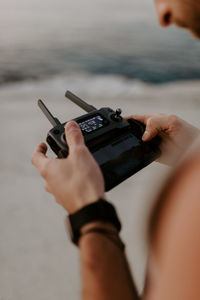 Cropped hands of man using mobile phone