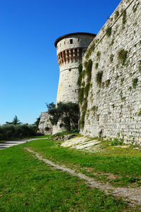 Low angle view of building against clear blue sky