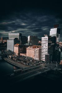 View of cityscape against cloudy sky