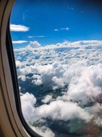 Aerial view of cloudscape seen through airplane window