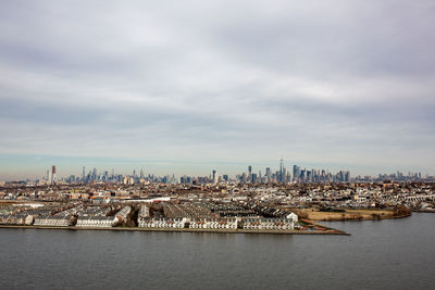 Scenic view of sea and buildings against sky