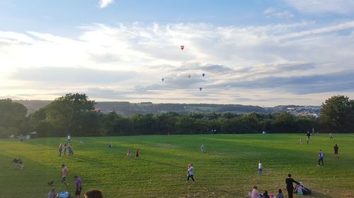 People playing soccer on grassy field