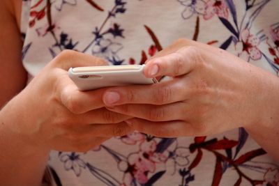 Midsection of woman using phone