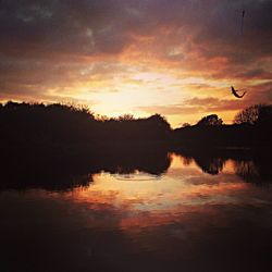 Scenic view of lake against sky during sunset