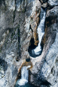 View of stream flowing through rocks