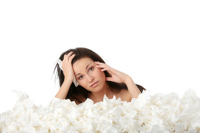 Portrait of a young woman lying on white background