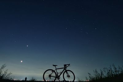 Low angle view of bicycles against sky at night