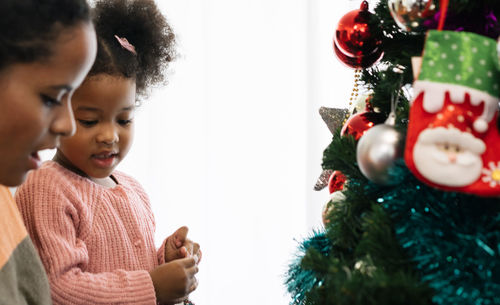 High angle view of girl with christmas tree