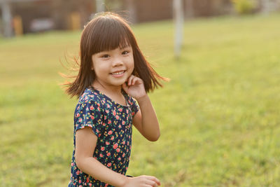 Portrait of smiling girl standing in park